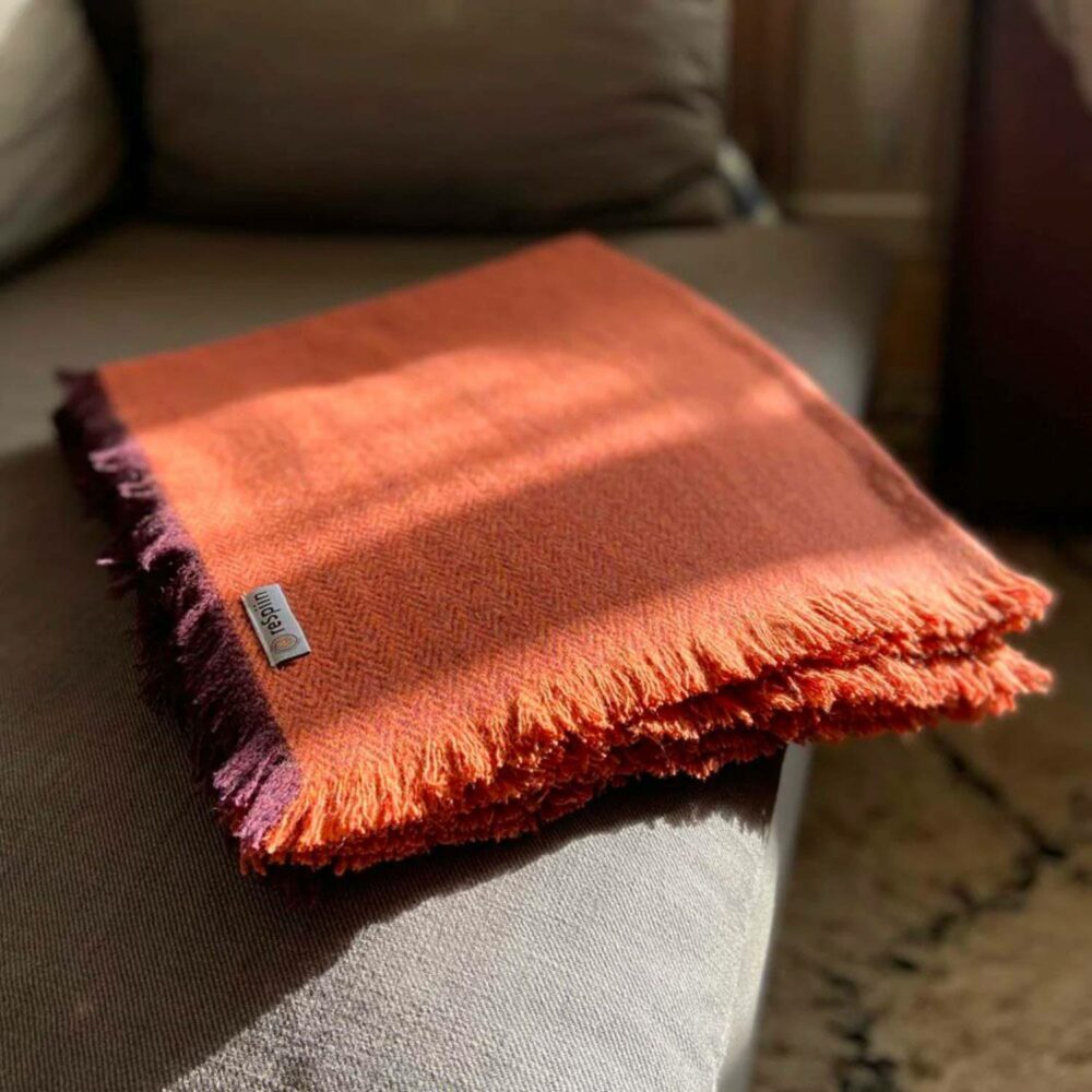 REspiin blanket/throw rust in sunshine on sofa