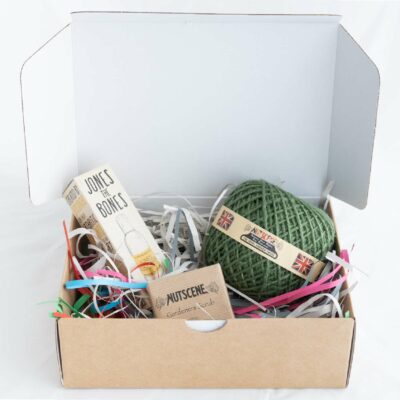 open box showing hamper contents of twine, soap and oil