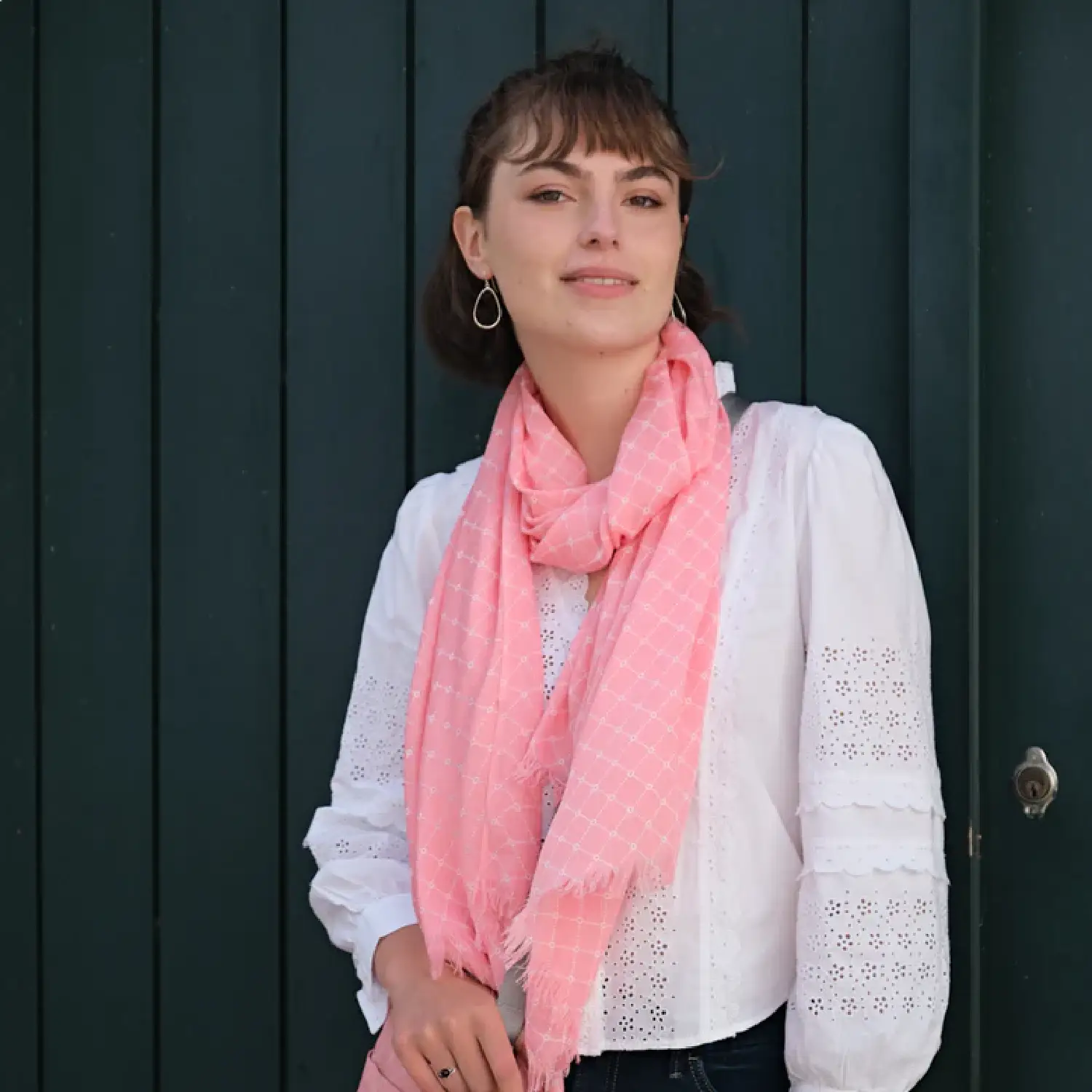 Woman wearing Earth Squared pink sorbet scarf