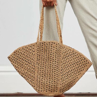 nomads chevron jute bag being held by the handles