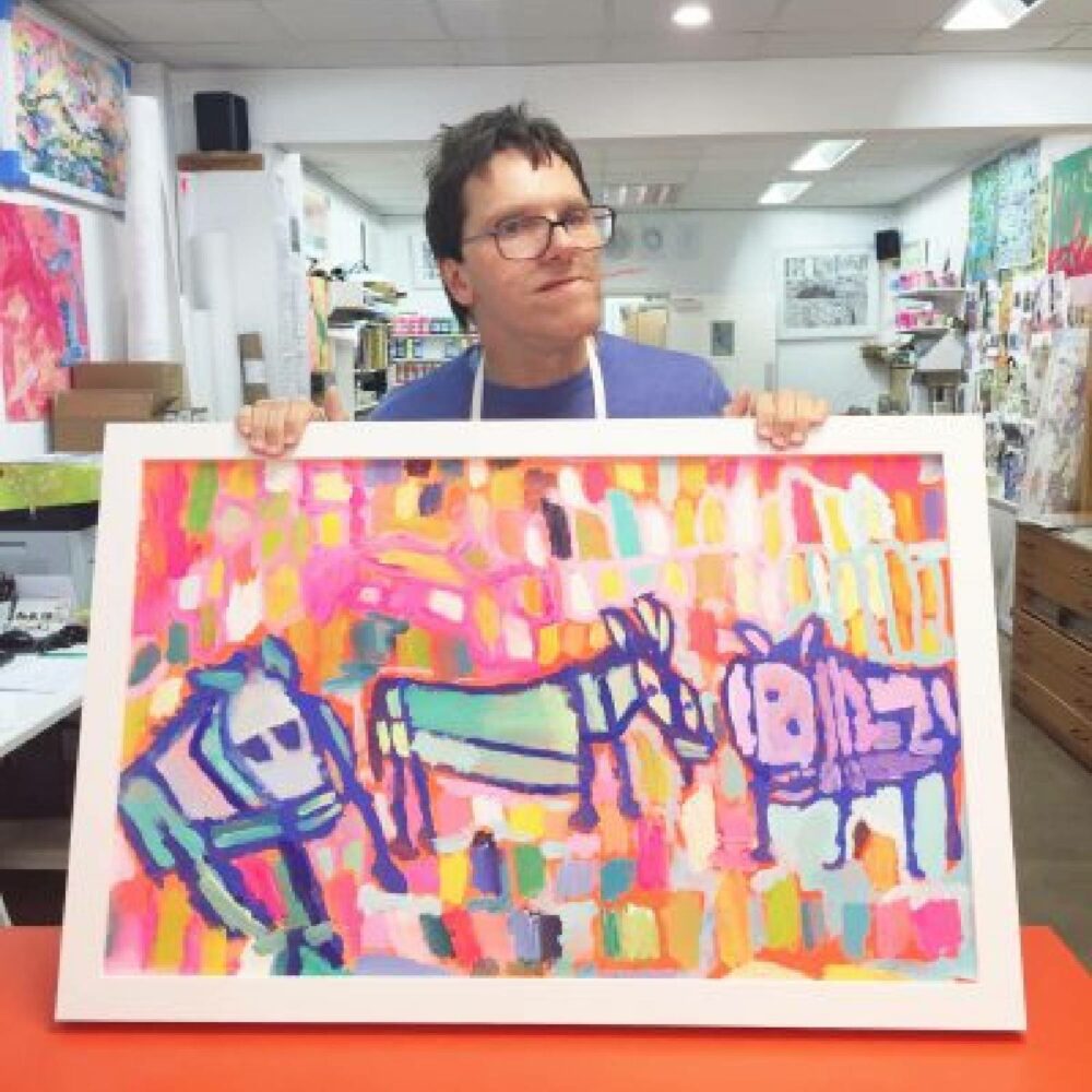artist Simon Hammond with the painting that was used for the packaging design
